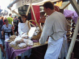 People in medieval clothes selling food at the Broerstraat street, during the Gebroeders van Limburg Festival