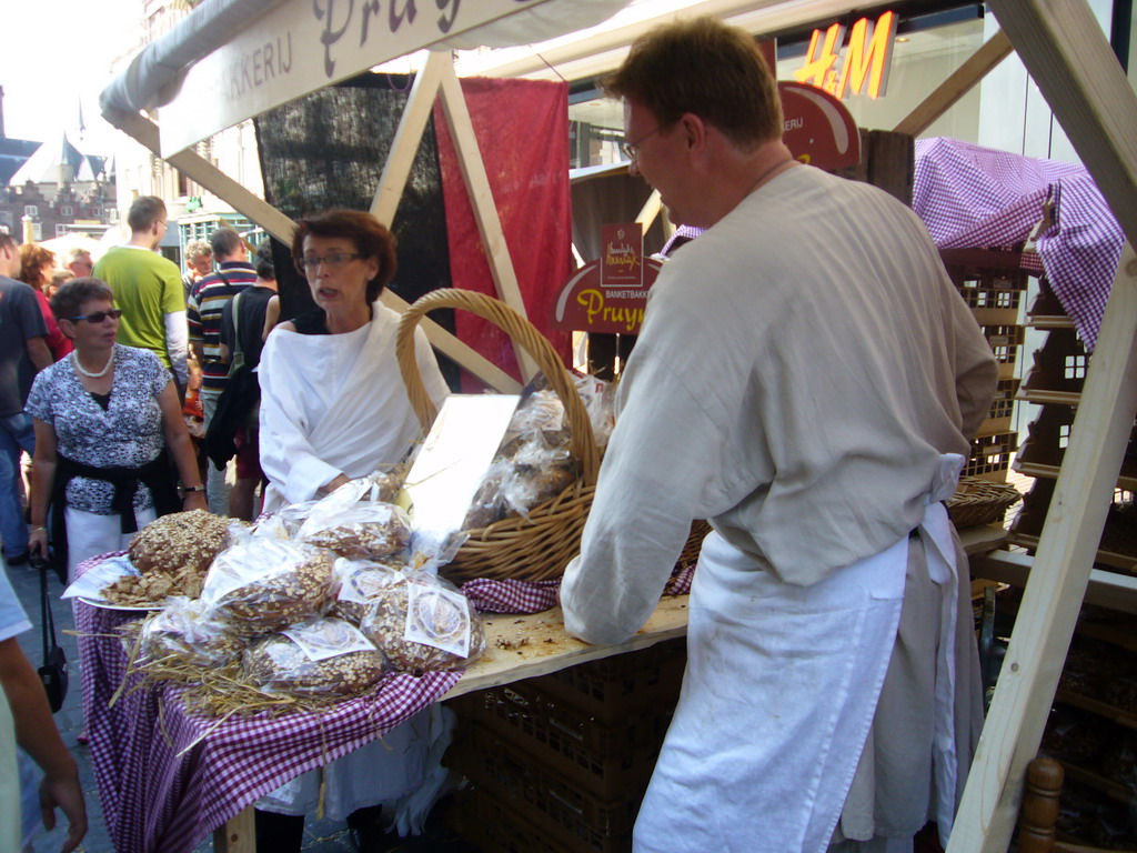 People in medieval clothes selling food at the Broerstraat street, during the Gebroeders van Limburg Festival