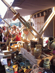 Person in medieval clothes selling pottery at the Broerstraat street, during the Gebroeders van Limburg Festival