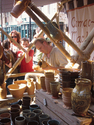 Person in medieval clothes selling pottery at the Broerstraat street, during the Gebroeders van Limburg Festival