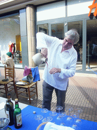 Person selling wine at the Broerstraat street, during the Gebroeders van Limburg Festival