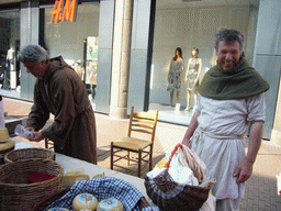 People in medieval clothes selling cheese at the Broerstraat street, during the Gebroeders van Limburg Festival