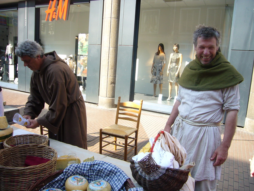 People in medieval clothes selling cheese at the Broerstraat street, during the Gebroeders van Limburg Festival