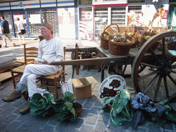 Person in medieval clothes selling vegetables at the Broerstraat street, during the Gebroeders van Limburg Festival