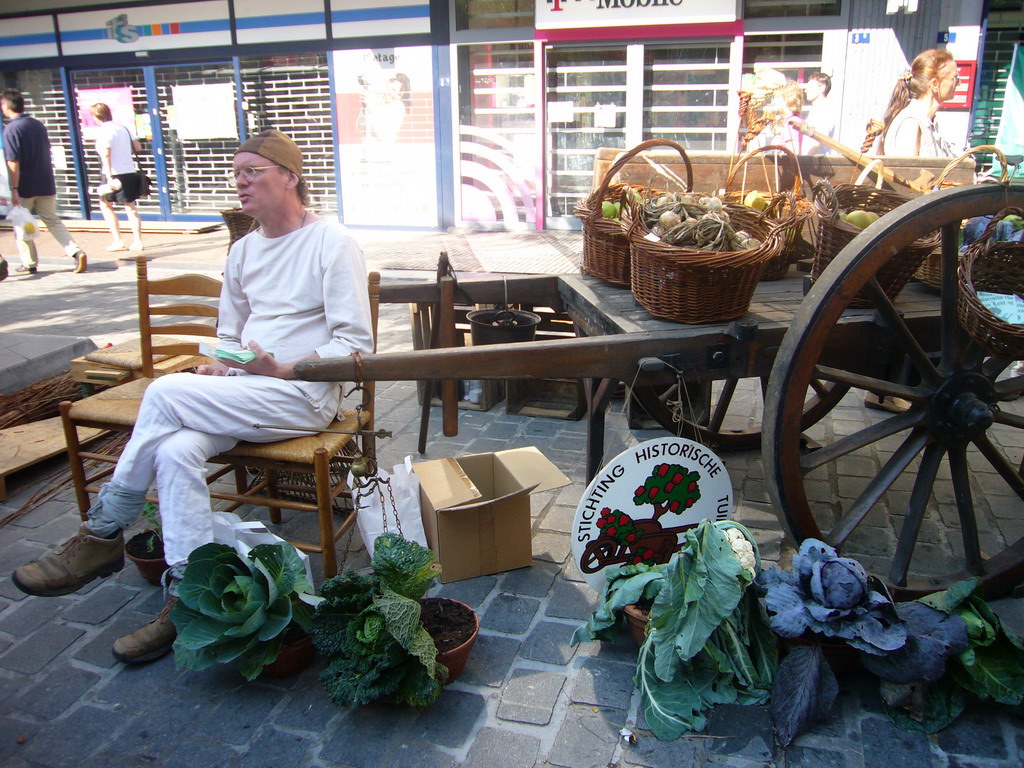Person in medieval clothes selling vegetables at the Broerstraat street, during the Gebroeders van Limburg Festival