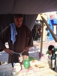 Person in medieval clothes selling wine at the Broerstraat street, during the Gebroeders van Limburg Festival