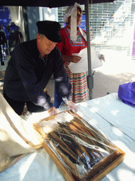 People in medieval clothes selling eel at the Broerstraat street, during the Gebroeders van Limburg Festival
