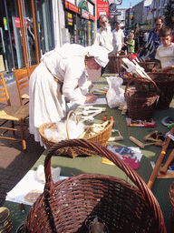 Person in medieval clothes selling wooden swords at the Broerstraat street, during the Gebroeders van Limburg Festival