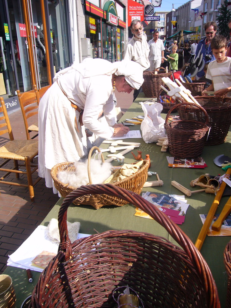 Person in medieval clothes selling wooden swords at the Broerstraat street, during the Gebroeders van Limburg Festival