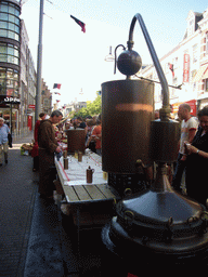 Person in medieval clothes selling wine at the Broerstraat street, during the Gebroeders van Limburg Festival