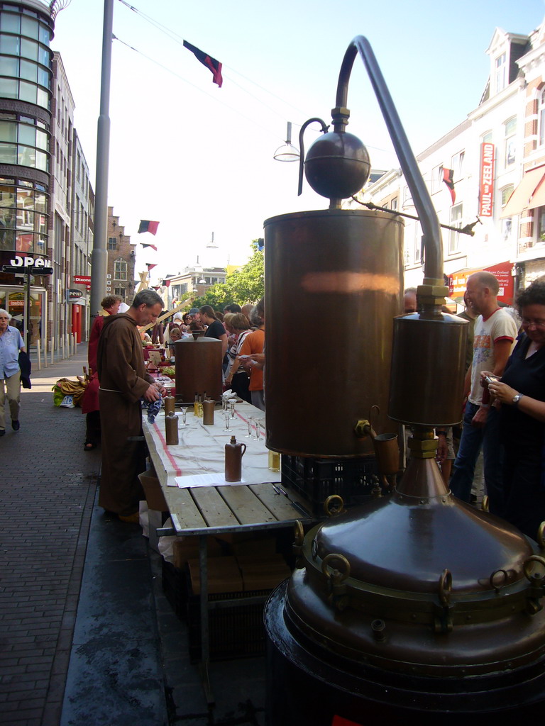 Person in medieval clothes selling wine at the Broerstraat street, during the Gebroeders van Limburg Festival