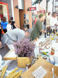 People in medieval clothes selling honey at the Broerstraat street, during the Gebroeders van Limburg Festival