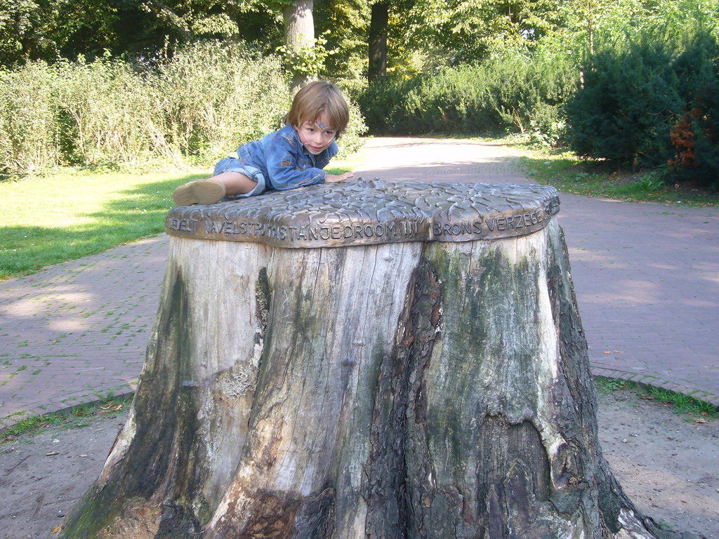 Child climbing on a tree trunk at the Valkhof park