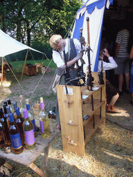 Person in medieval clothes holding swords at the Valkhof park, during the Gebroeders van Limburg Festival