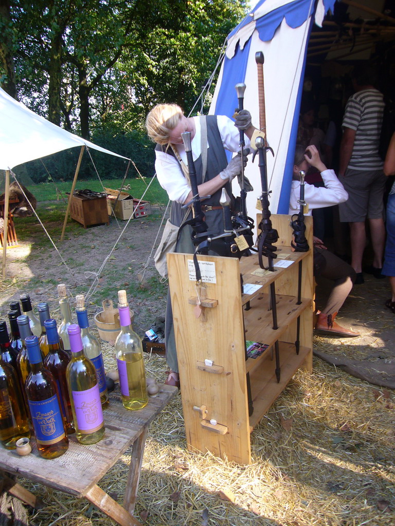 Person in medieval clothes holding swords at the Valkhof park, during the Gebroeders van Limburg Festival