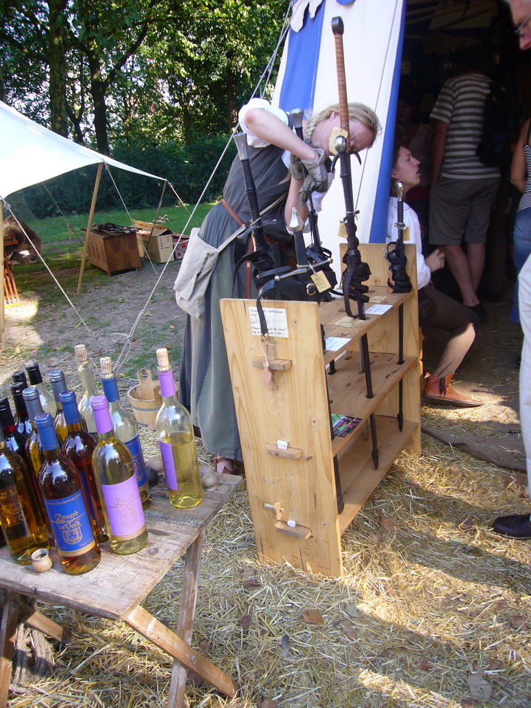 Person in medieval clothes holding swords at the Valkhof park, during the Gebroeders van Limburg Festival