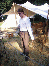 Person in medieval clothes holding armour at the Valkhof park, during the Gebroeders van Limburg Festival