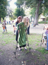 Child in medieval clothes walking on stilts at the Valkhof park, during the Gebroeders van Limburg Festival