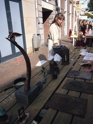 Person in medieval clothes selling art at the Broerstraat street, during the Gebroeders van Limburg Festival