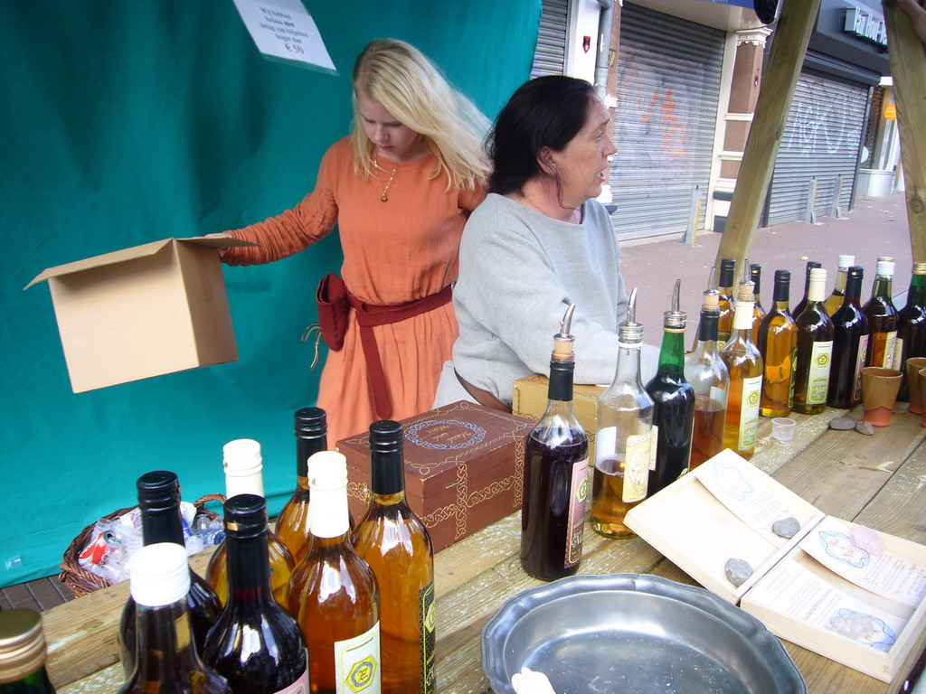 People in medieval clothes selling wine at the Broerstraat street, during the Gebroeders van Limburg Festival