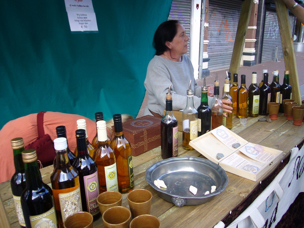 People in medieval clothes selling wine at the Broerstraat street, during the Gebroeders van Limburg Festival