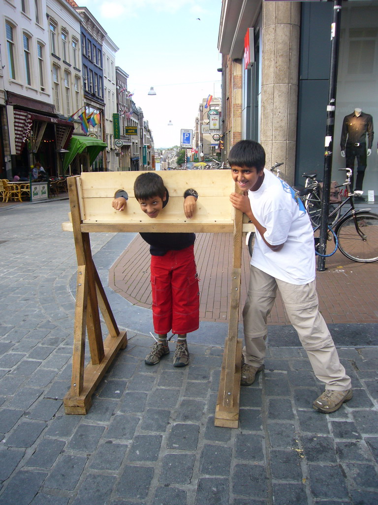 People in medieval clothes with a pillory at the Broerstraat street, during the Gebroeders van Limburg Festival