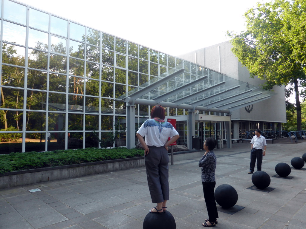 Miaomiao and her parents in front of the Aula building of the Radboud University Nijmegen at the Comeniuslaan street