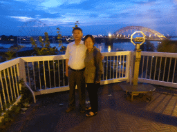 Miaomiao`s parents at the northwest side of the Valkhof park, with a view on the Waalbrug bridge over the Waal river and a ferris wheel, at sunset
