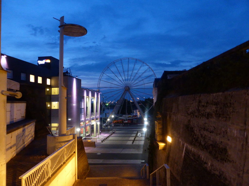 The Veerpoorttrappen staircase and the Waalkade promenade with a ferris wheel, at sunset