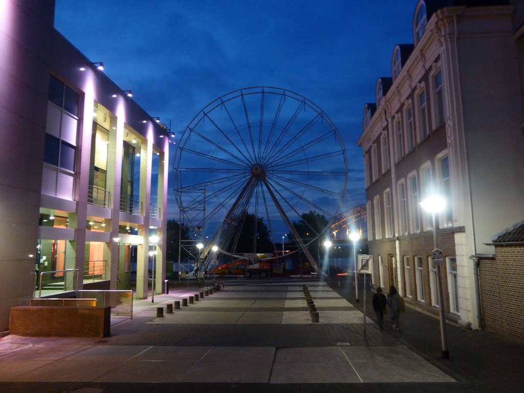 The Waalkade promenade with a ferris wheel and the Waalbrug bridge over the Waal river, at sunset