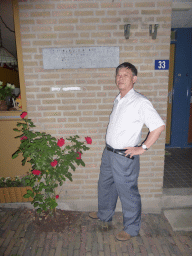Miaomiao`s father in front of the site at the Grotestraat street where Henriëtte Presburg, mother of Karl Marx, was born, by night