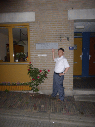 Miaomiao`s father in front of the site at the Grotestraat street where Henriëtte Presburg, mother of Karl Marx, was born, by night