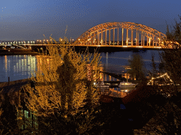 The Waalbrug bridge over the Waal river, viewed from the Valkhof park, by night