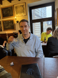 Tim with a Glühwein at the upper floor of the Café In de Blaauwe Hand