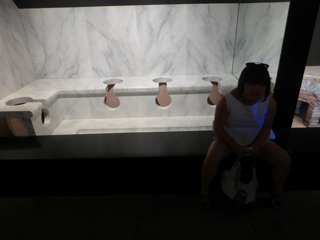 Miaomiao on a Roman toilet, at the ground floor of the Museum of the Pont du Gard aqueduct bridge