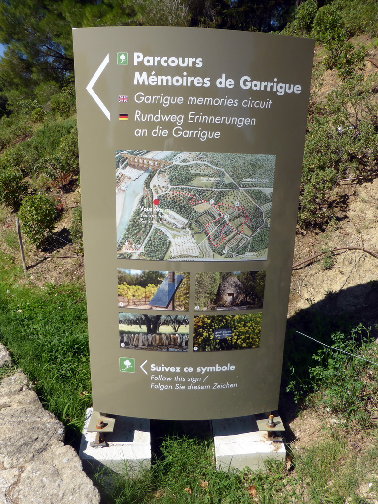 Sign of the Garrigue Memories Circuit, at the road on the northwest side of the Pont du Gard aqueduct bridge