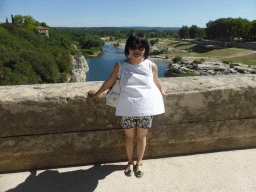 Miaomiao at the Pont du Gard aqueduct bridge, with a view on the north side of the Gardon river