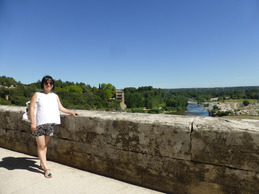 Miaomiao at the Pont du Gard aqueduct bridge, with a view on the north side of the Gardon river