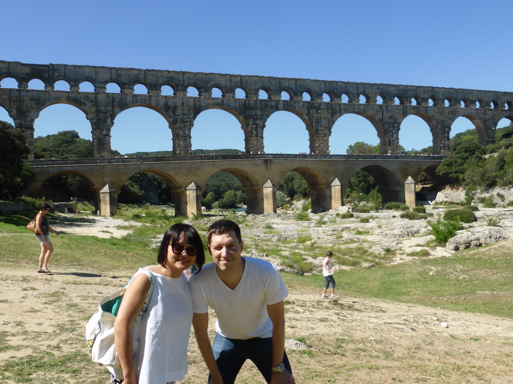 Tim and Miaomiao with the Pont du Gard aqueduct bridge and the grassland at the northeast side