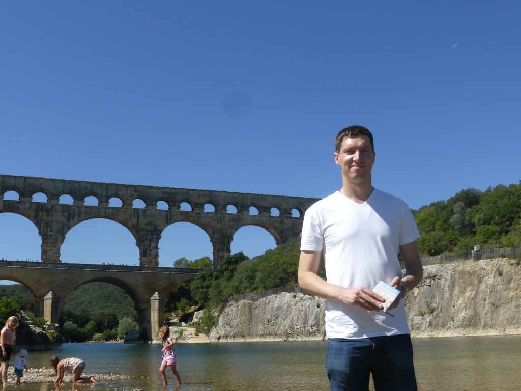 Tim at the north side of the Gardon river, with a view on the Pont du Gard aqueduct bridge