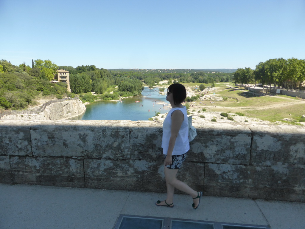 Miaomiao at the Pont du Gard aqueduct bridge, with a view on the north side of the Gardon river