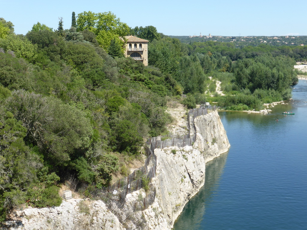 Building on the northwest side of the Pont du Gard aqueduct bridge, and the north side of the Gardon river, viewed from the Pont du Gard aqueduct bridge