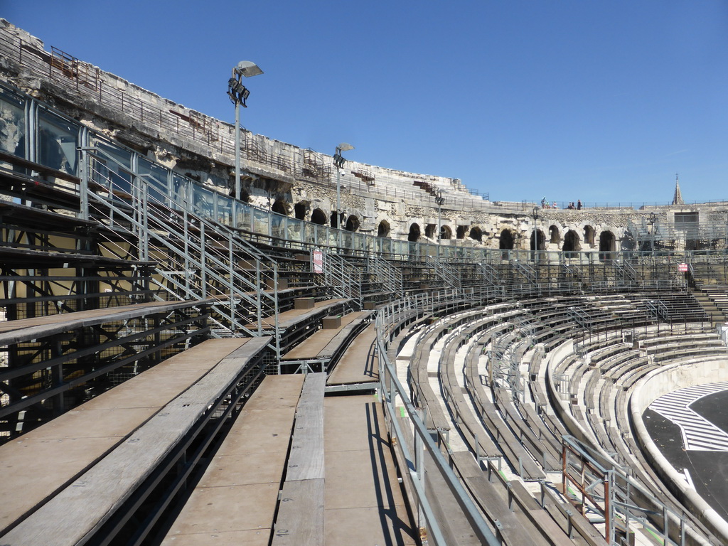 The upper middle rows of seats at the north side of the Arena of Nîmes