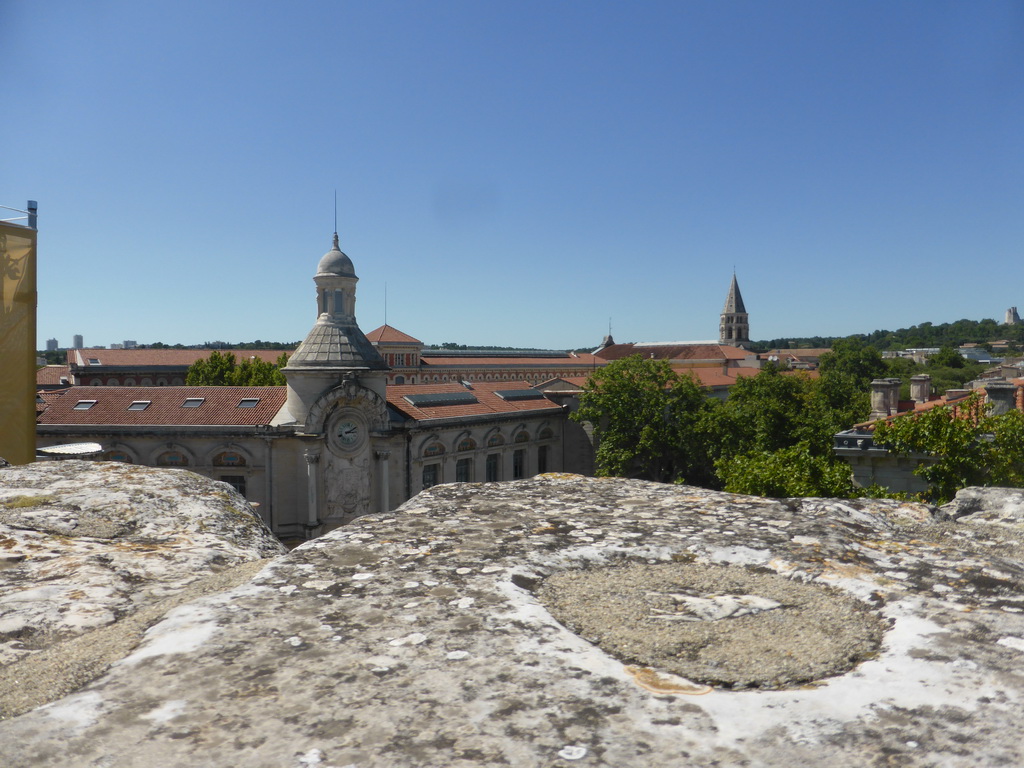 The Lycée Alphonse Daudet building and the tower of the Église Saint-Paul de Nîmes church, viewed from the top rows of seats of the Arena of Nîmes