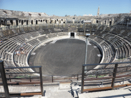 The northeast side of the interior of the Arena of Nîmes and the tower of the Eglise Sainte Perpétue church, viewed from the upper middle rows of seats