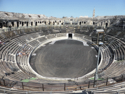 The northeast side of the interior of the Arena of Nîmes and the tower of the Eglise Sainte Perpétue church, viewed from the upper middle rows of seats