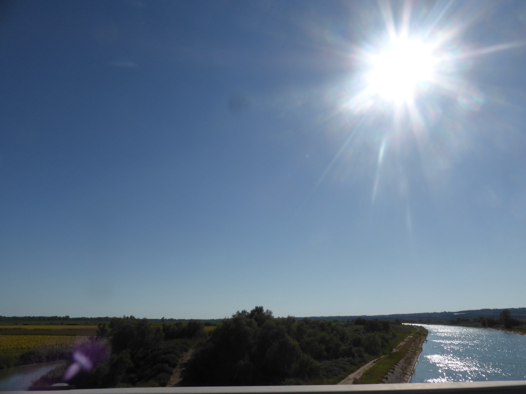 River and sunflower fields next to the road to Arles, viewed from our rental car