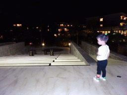 Max at the staircase from the lobby to the other buildings at the Inaya Putri Bali hotel, by night