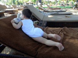 Max on a sunbed at the beach of the Inaya Putri Bali hotel