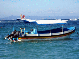 Boat in the Lombok Strait, viewed from the beach of the Inaya Putri Bali hotel